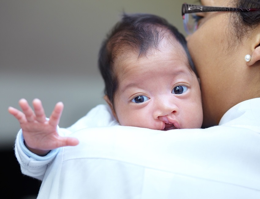 A nurse is holding a baby.