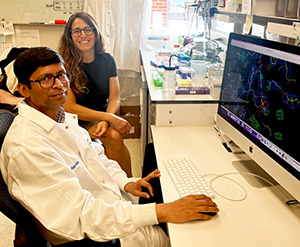 Two researchers, Nadine Samara and Pranav Kumar, work at a desk.