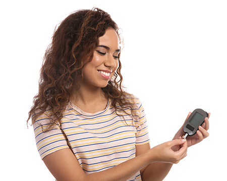 A woman holding a glucose monitor