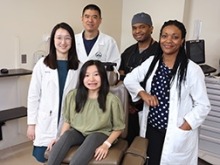 NIDCR clinical team poses with a patient.